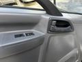 Interior door handle and window controls of a 2016 Isuzu NPR