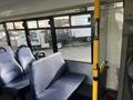 Interior view of a 2018 Chevrolet Express with blue upholstered seats and a yellow pole for support