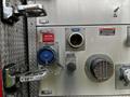 Close-up of a 2009 Spartan Gladiator fire truck panel featuring various dials and connectors including a blue valve and several warning labels