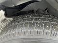 Close-up of a tire from a 2017 Chevrolet Express showing tread pattern and texture with dirt and debris on the surface