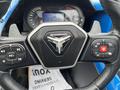 Close-up of a 2020 Polaris Slingshot steering wheel featuring multimedia controls and a central emblem with the Slingshot logo