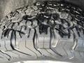 Close-up of a rugged tire from a 2015 RAM 1500 showcasing its deep tread pattern designed for off-road performance