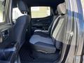 Interior view of a 2021 Toyota Tacoma focusing on the rear seating area with black and gray upholstery and a spacious design