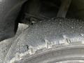 Close-up of a worn tire on a 2000 Hyster 120 forklift showing cracks and debris on the surface