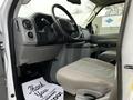 Interior view of a 2014 Ford Econoline showing the driver's seat dashboard and floor mat with a message thanking the driver