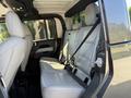 Interior of a 2021 Jeep Gladiator showing the backseat with two leather seats and seatbelts installed