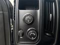 Control knobs and dial on the dashboard of a 2016 GMC Sierra 1500 for adjusting drive settings and headlight controls