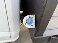 A blue DEF fill cap mounted on a white 2020 Ford F-550 truck