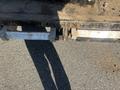2024 Southland 18 Foot Dump Trailer featuring a robust metal chassis and a loading ramp with two handles for easy operation