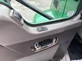 Interior view of a 2013 Kenworth T370 door panel featuring a window control button and a door handle
