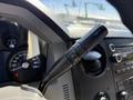The image shows the control stalk of a 2014 Ford F-250 SD featuring buttons for adjusting settings and a digital dashboard display behind it