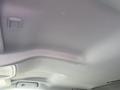 Interior view of a 2015 Chevrolet Silverado 1500 showing the ceiling with a smooth surface and an overhead light switch