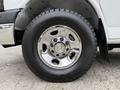 A chrome wheel with a Chevrolet logo mounted on a black tire of a 2013 Chevrolet Express