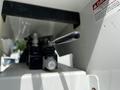 A close-up of a control lever on a 2012 Freightliner M2 106 showing a black handle with an attached valve assembly