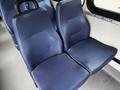 Two navy blue cushioned seats designed for a passenger van, featuring textured fabric and a sturdy black handle on the back of one seat