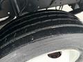 Close-up of a worn tire from a 2018 Ford E-450 showing visible tread depth and sidewall texture