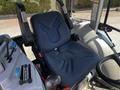 An operator's seat of a 2018 New Holland Boomer 45 tractor featuring a textured blue fabric design and a seatbelt