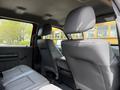 Interior view of a 2013 Ford F-550 featuring gray leather seats with a spacious backseat and armrest in the center