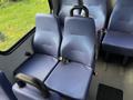 Two blue fabric upholstered seats with seat belts inside a 2020 Chevrolet Express van