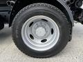 A close-up of a tire mounted on a 2009 Ford LCF 550 featuring a silver rim with a five-bolt pattern and a large tread design on the rubber surface