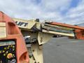 A 2009 JLG E300AJP aerial lift with an orange boom and control panel visible on the side showing various buttons and safety instructions