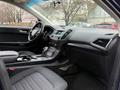 Interior view of a 2017 Ford Edge featuring a modern dashboard leather seats and a gear shift console