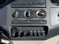 The dashboard controls of a 2008 Ford F-550 featuring knobs for temperature and air conditioning as well as auxiliary switches for various functions