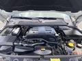 The engine compartment of a 2006 Land Rover LR3 showing the engine cover battery and various engine components