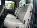 Interior view of a 2008 Ford F-550 showing the rear bench seat with light beige upholstery and seatbelts