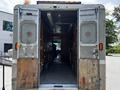 A 2008 Morgan Olson Workhorse with open rear doors revealing a spacious interior with wooden cabinetry and ventilation systems on each side