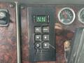 Close-up of the gear shift panel in a 2013 Kenworth T370 featuring buttons for selecting gears and a digital monitor display