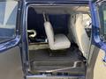 Interior view of a 2011 Ford Econoline showing the seating area with a single beige seat installed on the driver's side and an empty space on the passenger side