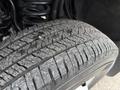 Close-up of a worn tire on a 2013 Ford F-350 SD showcasing detailed tread patterns and surface wear