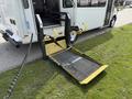 A 2010 Ford Econoline with a retractable wheelchair ramp extending from the side door