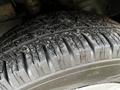 Close-up of a worn tire from a 2020 Ford Transit showing distinct tread patterns and surface texture