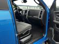 Interior view of a blue 2021 RAM 1500 Classic showcasing the driver's side seating and dashboard with gray fabric upholstery and modern controls