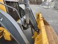 2011 John Deere 310SJ 4x4 Wheel Loader with an extended hoe and a 4 in 1 bucket visible in the foreground