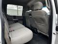 Interior view of a 2017 Ford F-550 showing the back row of seats with gray upholstery and a spacious layout