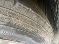 Close-up view of a worn tire from a 1987 Chevrolet Fleetwood Pace Arrow showing visible tread wear and dirt accumulation