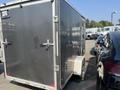2022 Discovery DMA61 14 Foot Cargo Trailer Ramp Gate with a sleek black exterior and a side door for access