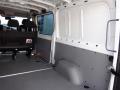 Interior view of a 2016 Mercedes-Benz Sprinter showing a spacious cargo area with gray walls and floor and a row of black seating positioned on one side