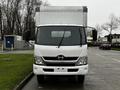 A front view of a white 2018 Hino 195 box truck with a large cargo area and side mirrors visible