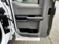 Interior door panel of a 2017 Ford F-150 featuring armrest door handle and storage compartment