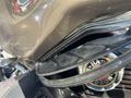 Close-up of a 2004 Harley-Davidson Flhtcui showing its chrome engine and distinctive badge with the Harley-Davidson logo