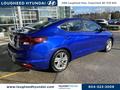 A blue 2020 Hyundai Elantra is parked with its side and rear view visible showcasing its sleek design and alloy wheels