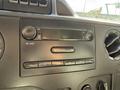 Dashboard of a 2012 Ford Econoline E-450 showing the radio controls and display