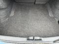 The interior of a 2022 Dodge Charger trunk showing a spacious and empty cargo area with grey carpeting