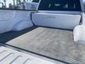 Interior of a 2017 Ford F-150 truck bed showing a diamond plate liner and an open storage area with no cargo present