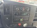 Dashboard of a 2018 Chevrolet Express with control knobs a digital clock and buttons for audio and climate control