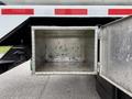 An open aluminum storage box attached to a 2016 Peterbilt 348 truck with a smooth interior and a textured exterior surface